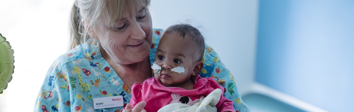 Paediatric nurse holding baby