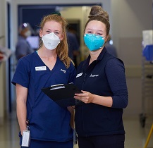 Two nurses in Austin Health uniform and masks.