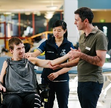 A physiotherapy student working with a patient and clinical educator.