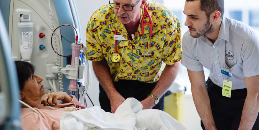 Aboriginal patient Julie Peers having dialysis, cared for by a nurse and student nurse