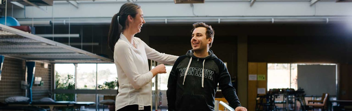 A physio works with a spinal rehabilitation patient