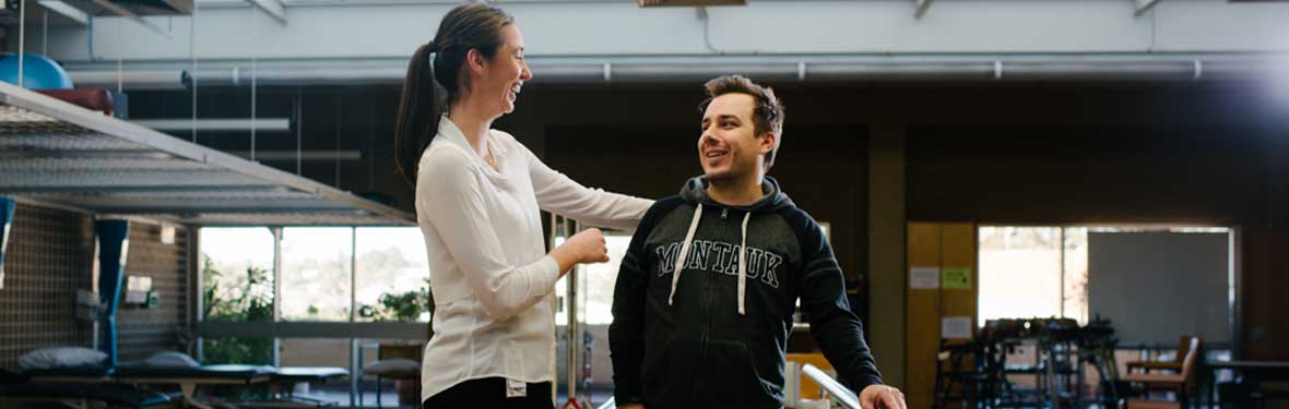 A physio works with a spinal rehabilitation patient