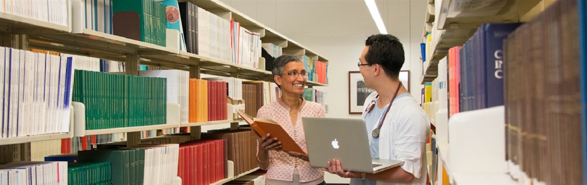 A librarian helping a health professional to locate a book.